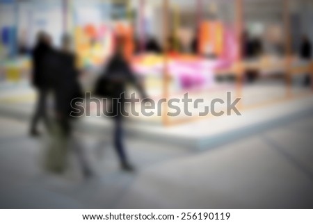 People walking. Intentionally blurred editing post production. Humans, location and products not recognizable.