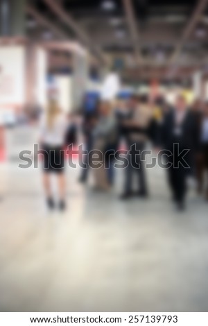 Trade show people, generic background. Intentionally blurred editing post production.