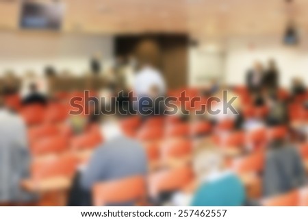 People in meeting, background. Intentionally blurred editing post production.