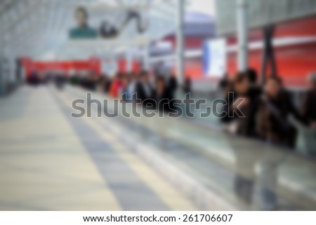 People arrive at trade show, background. Intentionally blurred editing post production.