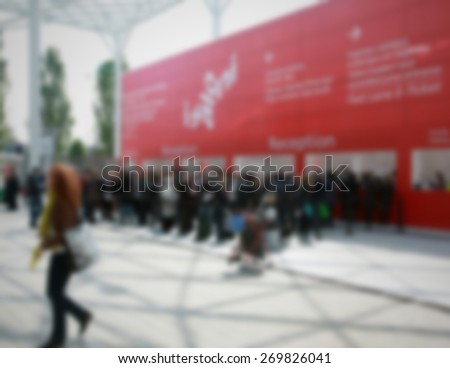 People at trade show, generic background. Intentionally blurred editing post production.