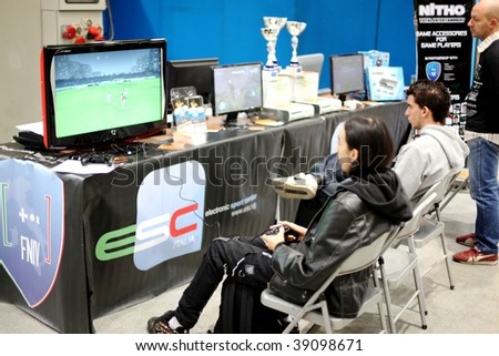 MILAN, ITALY - OCT. 16: Children playing video games at Ludica stands, area dedicated to gaming at Hobby Show, Italian showroom of the fine arts and manual creativity October 16, 2009 in Milan, Italy.