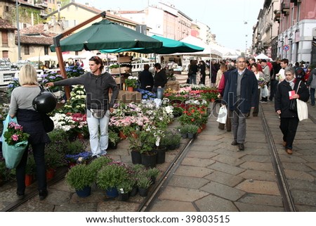 MILAN, ITALY - APRIL 5: People walking trough the garden market during the national exhibition Flowers and Flavours in the fashion and culture Navigli area April 5, 2009 in Milan, Italy.