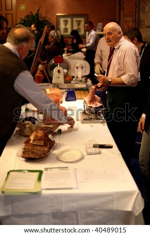 MILAN, ITALY - NOV. 8: A ham producer talks to people at Golosaria, national fair of food and gastronomy culture November 9, 2009 in Milan, Italy.
