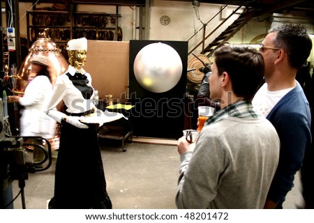 MILAN, ITALY - APRIL 20: People meet one of the robots in exhibition at Fuorisalone, fashion and design festival show April 20, 2009 in Milan, Italy.