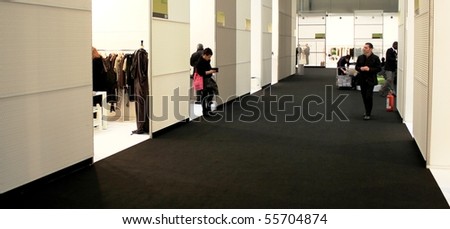 MILAN, ITALY - FEBRUARY 26: People trough stands at Milano women\'s prêt-à-porter, autumn and winter collections February 26, 2010 in Milan, Italy.