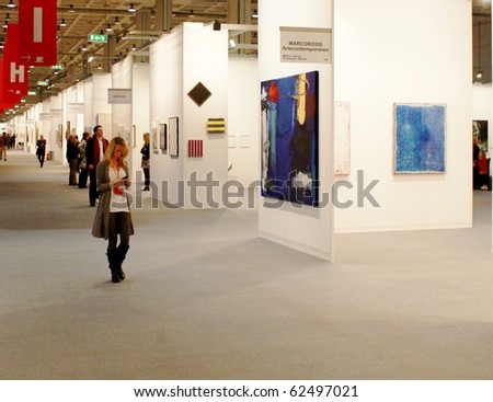 MILAN - MARCH 27: Visitors walk trough painting galleries at MiArt ArtNow, international exhibition of modern and contemporary art March 27, 2010 in Milan, Italy.