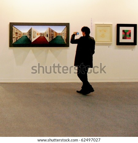 MILAN - MARCH 27: People look at painting galleries at MiArt ArtNow, international exhibition of modern and contemporary art March 27, 2010 in Milan, Italy.