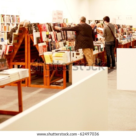 MILAN - MARCH 27: People look for art books at MiArt ArtNow, international exhibition of modern and contemporary art March 27, 2010 in Milan, Italy.