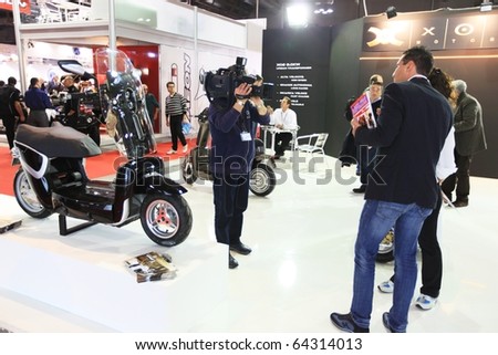 MILAN, ITALY - NOV. 03: TV interviews trough stands at EICMA, 68th International Motorcycle Exhibition November 03, 2010 in Milan, Italy.