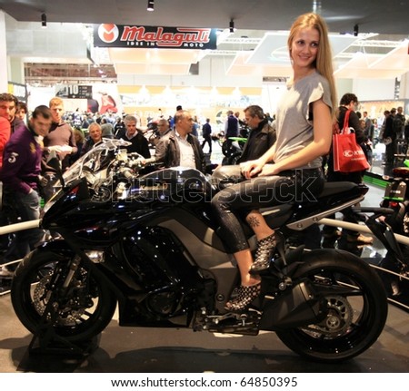MILAN, ITALY - NOV. 03: Top model on motorcycle during EICMA, 68th International Motorcycle Exhibition November 03, 2010 in Milan, Italy.