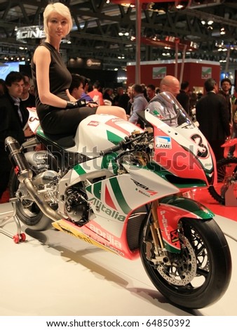 MILAN, ITALY - NOV. 03: Top model on SBK motorcycle in exhibition at EICMA, 68th International Motorcycle Exhibition November 03, 2010 in Milan, Italy.