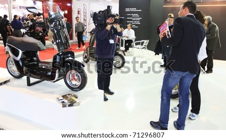 MILAN, ITALY - NOV. 03: Journalist interview at one of the stands during EICMA, 68th International Motorcycle Exhibition November 03, 2010 in Milan, Italy.