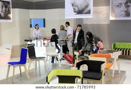 MILAN - APRIL 15: People look at home interior design and decoration stands during Salone del Mobile, international furnishing accessories showcase April 15, 2010 in Milan, Italy.