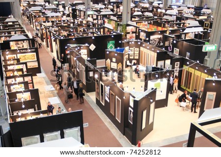 MILAN, ITALY - MARCH 26: Panoramic view of people visiting frames and art stands at Frame Art Expo, Photoshow, International Photo and Digital Imaging Exhibition on March 26, 2011 in Milan, Italy.
