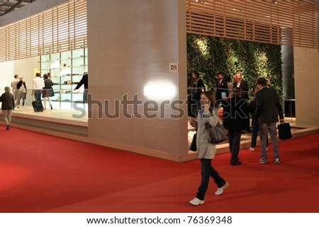 MILAN - APRIL 13: People look at interiors design stands and home architecture solutions at Salone del Mobile, international furnishing accessories exhibition on April 13, 2011 in Milan, Italy.