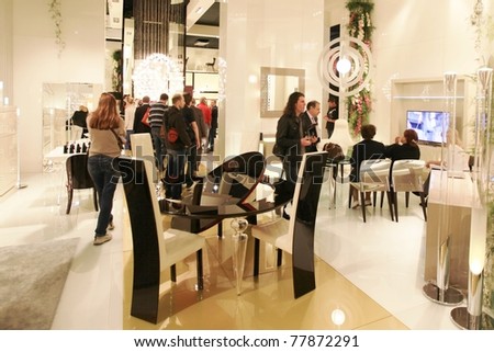 MILAN - APRIL 13: People look for interiors design stands and home architecture solutions at Salone del Mobile, international furnishing accessories exhibition on April 13, 2011 in Milan, Italy.
