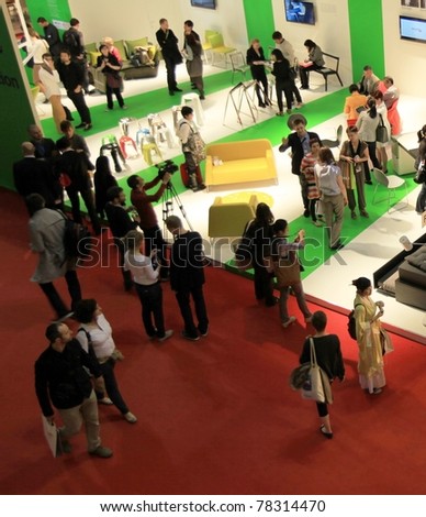 MILAN - APRIL 13: People looking at Interior design solutions visiting stands at Salone del Mobile, international furnishing accessories exhibition on April 13, 2011 in Milan, Italy.