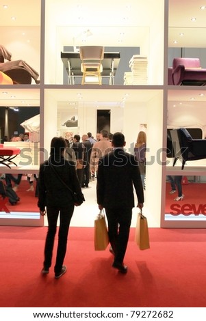 MILAN - APRIL 13: Visitors look at interior design solutions walking trough stands at Salone del Mobile, international furnishing accessories exhibition on April 13, 2011 in Milan, Italy.