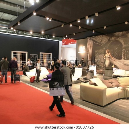 MILAN - APRIL 13: People visit interiors design stands looking for home architecture solutions at Salone del Mobile, international furnishing accessories exhibition on April 13, 2011 in Milan, Italy.