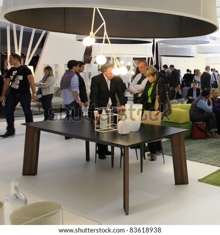 MILAN - APRIL 13:Visitors look at interiors design stands and home architecture solutions visiting Salone del Mobile, international furnishing accessories exhibition on April 13, 2011 in Milan, Italy.