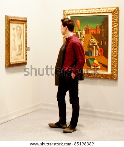 MILAN - MARCH 27: A man looks at a painting of arts galleries during MiArt ArtNow, international exhibition of modern and contemporary art March 27, 2010 in Milan, Italy.