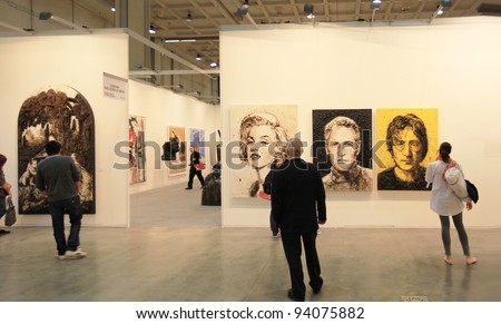 MILAN - APRIL 08: People look at paintings dedicated to Marilyn Monroe, Paul Newman and John Lennon at MiArt, international exhibition of modern and contemporary art on April 08, 2011 in Milan, Italy.