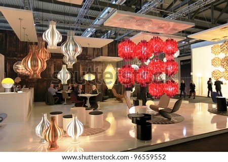 MILAN - APRIL 13: People visit interior lights design exhibition area at Salone del Mobile, international furnishing accessories exhibition on April 13, 2011 in Milan, Italy.