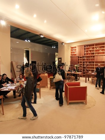 MILAN - APRIL 13: Visitors look at interiors design stands and home architecture solutions during Salone del Mobile, international furnishing accessories exhibition on April 13, 2011 in Milan, Italy.