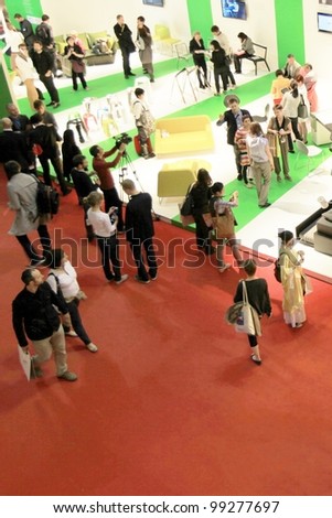 MILAN - APRIL 13: People look at interiors design solutions at Salone del Mobile, international furnishing accessories exhibition on April 13, 2011 in Milan, Italy.