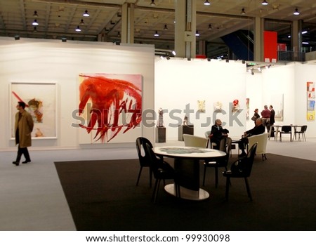 MILAN - MARCH 27: People look at paintings in exhibition at MiArt ArtNow, international exhibition of modern and contemporary art March 27, 2010 in Milan, Italy.