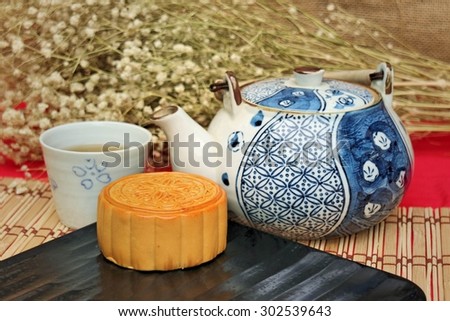 Traditional mooncakes and tea on table with teacup, Retro vintage style Chinese mid autumn festival foods