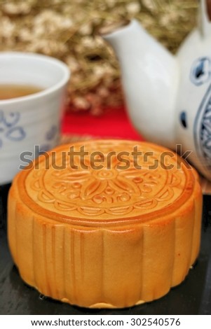 Traditional mooncakes and tea on table with teacup, Retro vintage style Chinese mid autumn festival foods