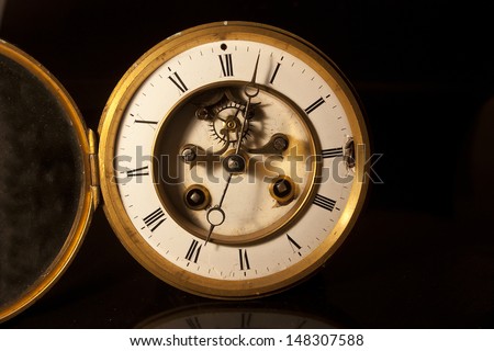 showing the face and dial of an old antique british victorian clock