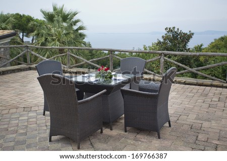 Overlooking The Italian Ocean With Roses On The Table