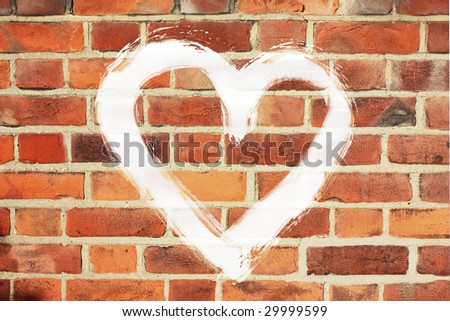 painted white big heart on old brick wall
