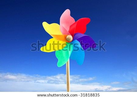 close up of a toy windmill outside at the beach