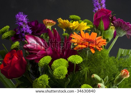 bouquet or bunch of tropical flowers on black