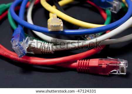 Set of brightly coloured ethernet network cables on white background