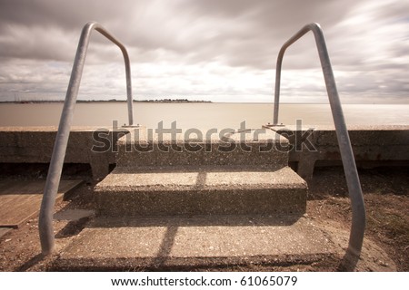 concrete steps lead down into murky water in essex