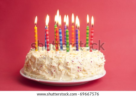 birthday cake with lots of candles on a red background