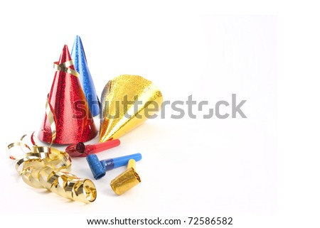 Party hats, blower and streamers isolated on white