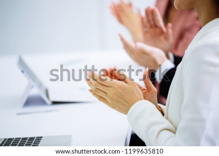 Businessman and business women clap their hands to congratulate the signing of an agreement or contract between their companies. concept of success, dealing, greeting and winning.