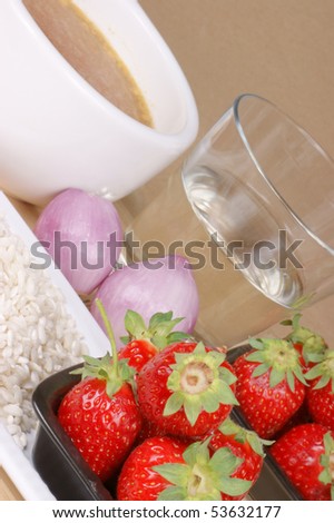 Ingredients for risotto with strawberries: rice, strawberries, shallot, white wine and vegetable stock. Selective focus, shallow DOF.