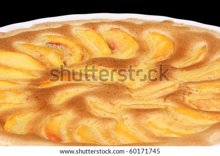Peach tart in a white pottery cake tin. Isolated on black with clipping path.