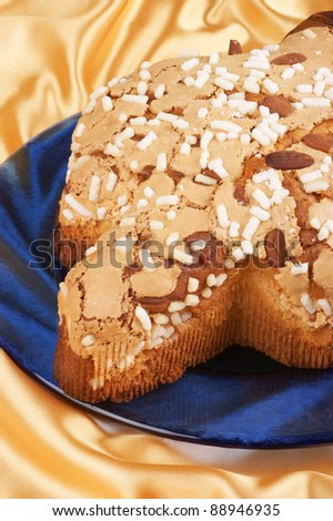 Colomba pasquale (Easter Dove) on a glass blue plate. It is a typical italian eastern cake. It is similar to panettone and has the shape of a dove.