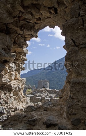 Chateau Puilaurens, one of the cathar castles in the midi pyrenees - languedoc - in south france. View trough an archway