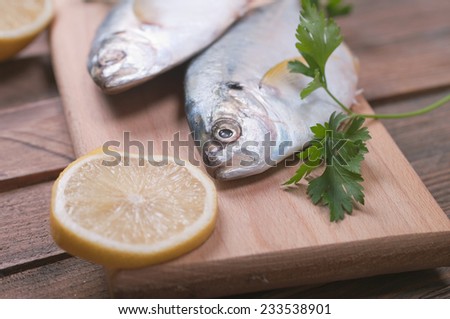 Delicious fresh sea bream fish on wooden kitchen board