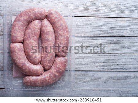 sausages in a plastic packaging tray