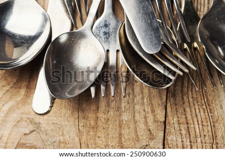 old cutlery on wooden table